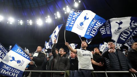 Spurs fans wave flags before the first Premier League game at the new stadium.