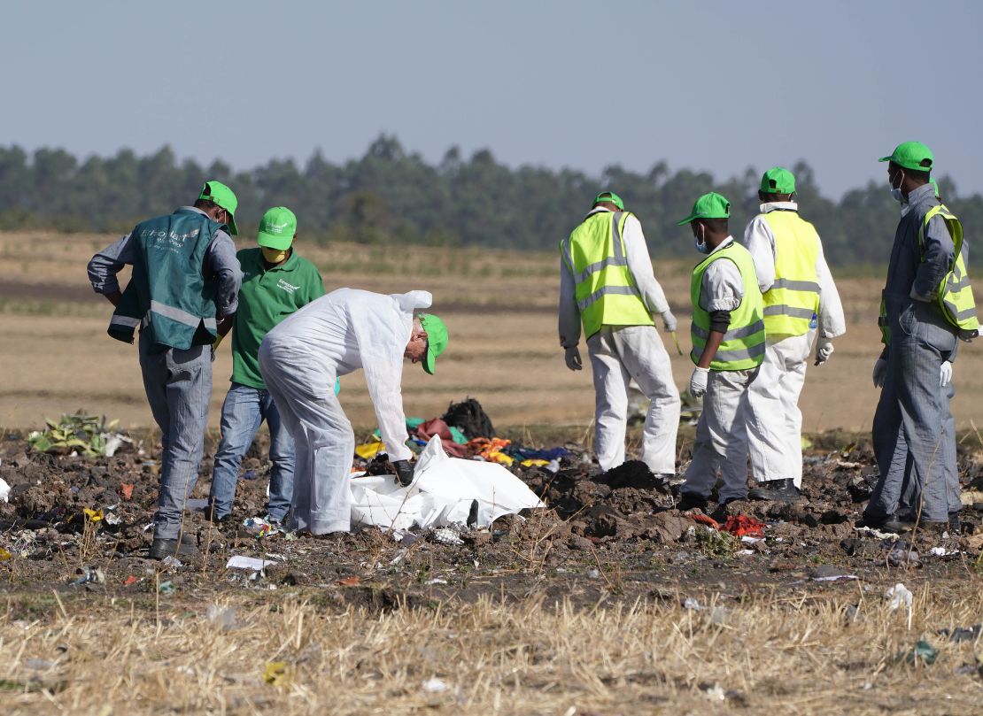 Investigators collect personal effects and other materials from the crash site of Ethiopian Airlines Flight 302.