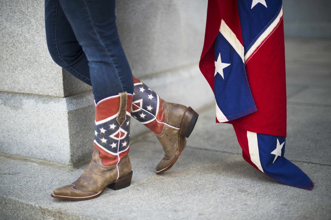A pro-confederate flag demonstrator wears confederate battle flag cowboy boots outside the South Carolina State House in Columbia, South Carolina, June 27, 2015.