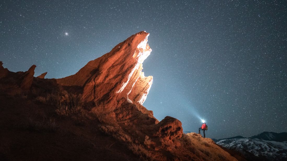 <strong>The Iceberg: </strong>Kyrgyz tour guide Timur Akbashev posed for this night shot in front of a backdrop of stars in a location known as "Mars Canyon." Click through the gallery for more of Dros's images.  