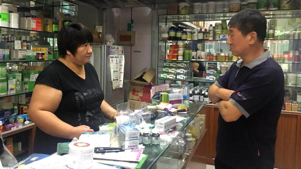 Pigeon racer Zhang Yajun buying medicine for his birds. The costs of keeping pigeons can be extensive.