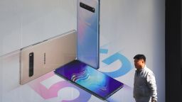 A man walks past an advertisement for the Samsung Galaxy S10 5G smartphone in Seoul on April 4, 2019. - South Korea launched the world's first nationwide 5G mobile networks two days early, its top mobile carriers said on April 4, giving a handful of users access in a late-night scramble to be the first providers of the super-fast wireless technology.