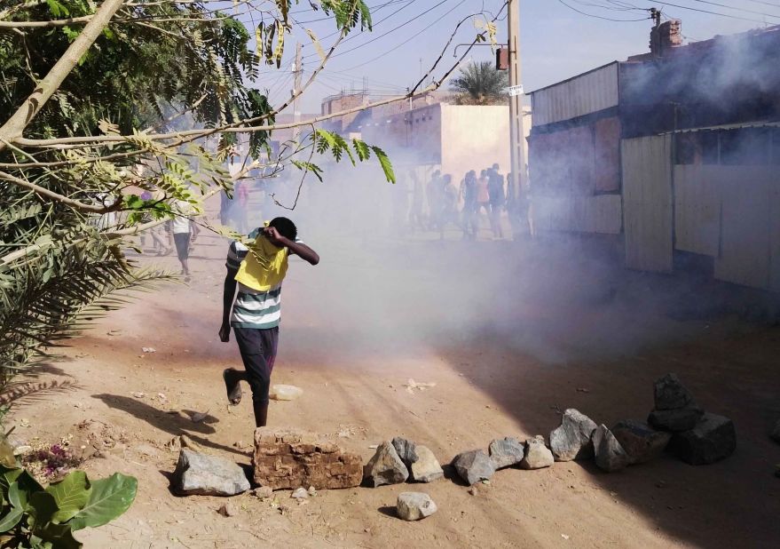 A protester retreats from tear gas during an anti-government demonstration on February 24.