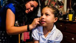 Dana's sister, Norkys Cabezas, 18, helps her get dressed for school every morning. 