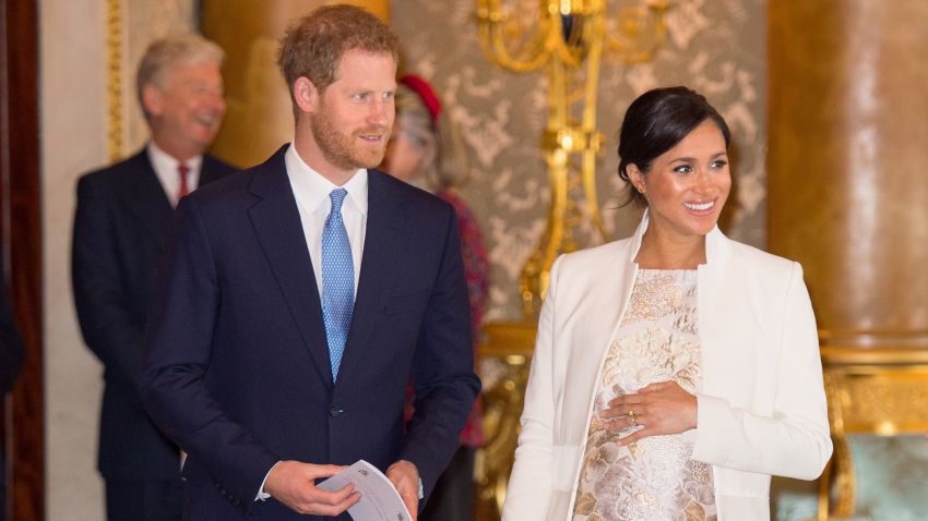 Britain's Prince Harry, Duke of Sussex, (L) and Britain's Meghan, Duchess of Sussex (R) attend a reception to mark the 50th Anniversary of the investiture of The Prince of Wales at Buckingham Palace in London on March 5, 2019. - The Queen hosted a reception to mark the Fiftieth Anniversary of the investiture of Britain's Prince Charles, her son, as the Prince of Wales. Prince Charles was created The Prince of Wales aged 9 on July 26th 1958 and was formally invested with the title by Her Majesty The Queen on July 1st 1969 at Caernarfon Castle.