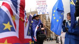 A pro-EU campaigner holds the EU flag and displays placards near the Houses of Parliament in central London on April 3, 2019. - Prime Minister Theresa May was to meet Wednesday with Britain's main opposition party leader in a bid to forge a Brexit compromise that avoids a dreaded "no-deal" departure from the EU in nine days. (Photo by ISABEL INFANTES / AFP)        (Photo credit should read ISABEL INFANTES/AFP/Getty Images)