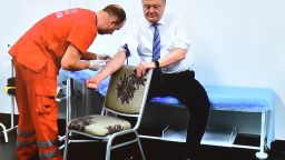 A TV screen made available for journalists to watch during a press conference, shows Ukrainian President Petro Poroshenko undergoing a blood test in a clinic of the Olimpiyski, the country's biggest stadium, in Kiev on April 5, 2019, to prove he does not abuse alcohol and drugs ahead of a second-round runoff on April 21. - Ukraine's incumbent leader, 53-years-old, is eager to spar with his political novice rival, giving him a chance to show off his debating skills and outflank comedian Volodymyr Zelensky, 41-years-old, before a run-off vote on April 21. But he had to agree to a number of unusual conditions set down by , including a requirement for both of them to undergo medical tests to prove they do not abuse alcohol or drugs. (Photo by Sergei SUPINSKY / AFP)        (Photo credit should read SERGEI SUPINSKY/AFP/Getty Images)