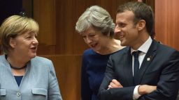 (From L) German Chancellor Angela Merkel, Britain Prime minister Theresa May and French President Emmanuel Macron talk as they arrive in Brussels, on October 19, 2017 during the summit of European Union (EU) leaders, set to rule out moving to full Brexit trade talks after negotiations stalled. / AFP PHOTO / JOHN THYS        (Photo credit should read JOHN THYS/AFP/Getty Images)