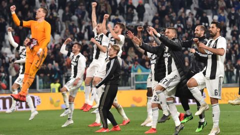 Juventus players celebrate after beating Milan 2-1 to close in on the Serie A title.