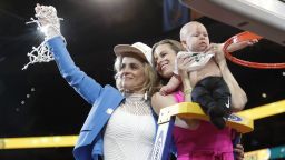Baylor coach Kim Mulkey, left, waves the net while standing with daughter and assistant coach Makenzie Fuller and Fuller's son, Kannon Reid Fuller, after the Final Four championship game of the NCAA women's college basketball tournament Sunday, April 7, 2019, in Tampa, Fla. Baylor defeated Notre Dame 82-81. (AP Photo/John Raoux)