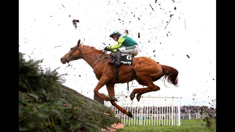 Jockey Nico de Boinville riding Topofthegame clears the last fence in the Betway Mildmay Novices' Chase during Ladies Day at Aintree Racecourse in Liverpool on April 5.