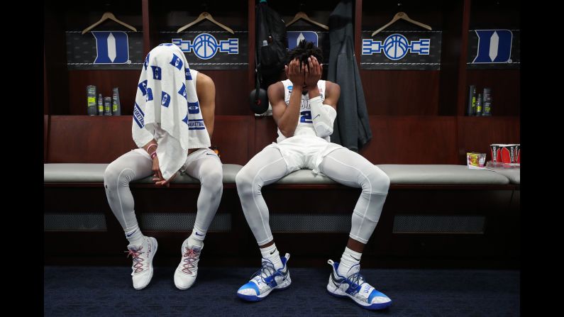 From left, Duke Blue Devils teammates Tre Jones and Cam Reddish sit in front of their lockers after a 68-67 loss to the Michigan State Spartans in the East Regional finals of the 2019 NCAA Men's Basketball Tournament at Capital One Arena on March 31.