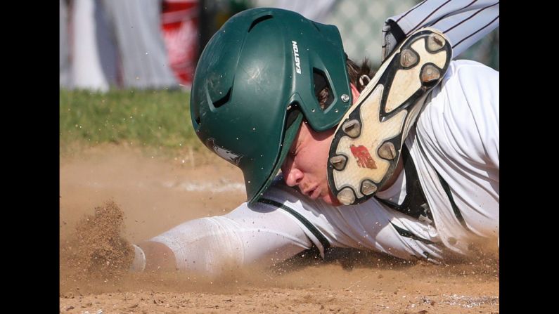 St. Mark's Nick Pisorchik slides into home plate under the tag of Appoquinimink pitcher Mason Keene during the third inning of a baseball game at St. Mark's High School in Wilmington, Delaware, on April 5.