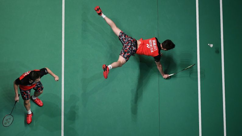 Indonesia's Kevin Sanjaya Sukamuljo, right, dives for a return while teammate Marcus Fernaldi Gideon looks on during their men's doubles quarter-final match against Fajar Alfian and Muhammad Rian Ardianto at the Malaysia Open badminton tournament in Kuala Lumpur on April 5.