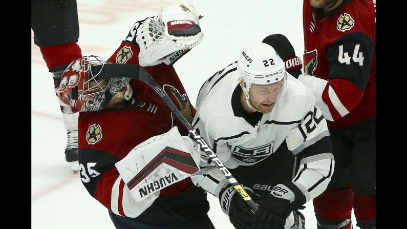 Arizona Coyotes goaltender Darcy Kuemper is hit in the face by the stick of Los Angeles center Trevor Lewis during the third period of an NHL hockey game in Glendale, Arizona, on April 2. The Kings defeated the Coyotes 3-1.