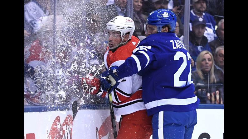 Carolina Hurricanes forward Greg McKegg is checked into the boards by Toronto Maple Leafs defenseman Nikita Zaitsev during the first period of their game at Scotiabank Arena in Toronto on April 2.