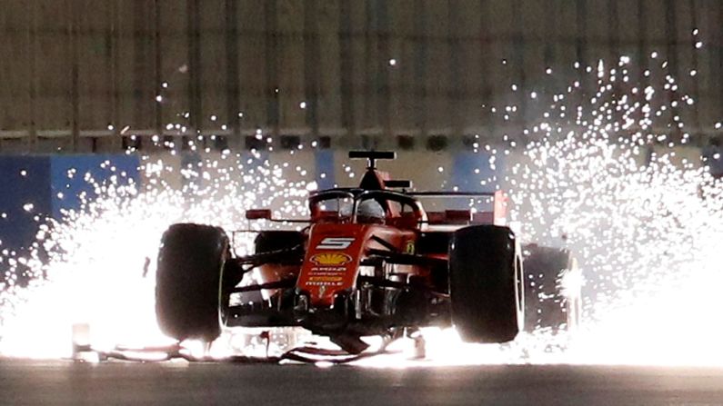 A damaged car driven by Sebastian Vettel sends sparks flying during the Formula One Bahrain Grand Prix on Sunday, March 31.