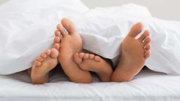 01 couples feet in bed STOCK
