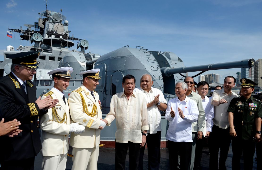 Philippines' President Rodrigo Duterte (4th L) shake hands with Russia's Rear Admiral Eduard Mikhailov (3rd L) onboard the Russian anti-submarine navy ship Admiral Tributs in Manila on January 6, 2017. 