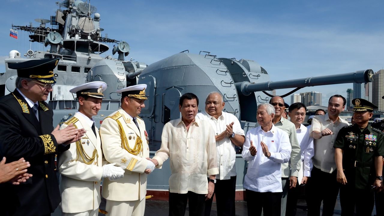 Philippines' President Rodrigo Duterte (4th L) shake hands with Russia's Rear Admiral Eduard Mikhailov (3rd L) onboard the Russian anti-submarine navy ship Admiral Tributs in Manila on January 6, 2017.