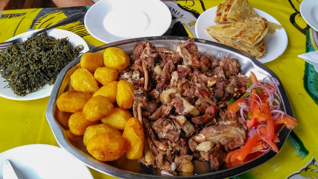 <strong>Nyama choma:</strong> A sharing platter of roast goat, <strong>kachumbari </strong>(salsa), <strong>sukuma wiki</strong> (collard greens), <strong>chapati</strong> and <strong>viazi</strong> (potatoes). Top tip: Eat it with your hands. 