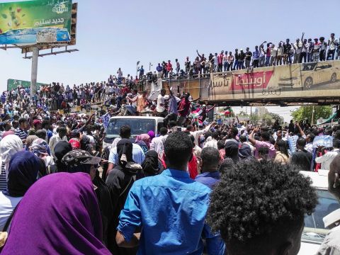 People protest on April 8, in front of the military headquarters in Khartoum.