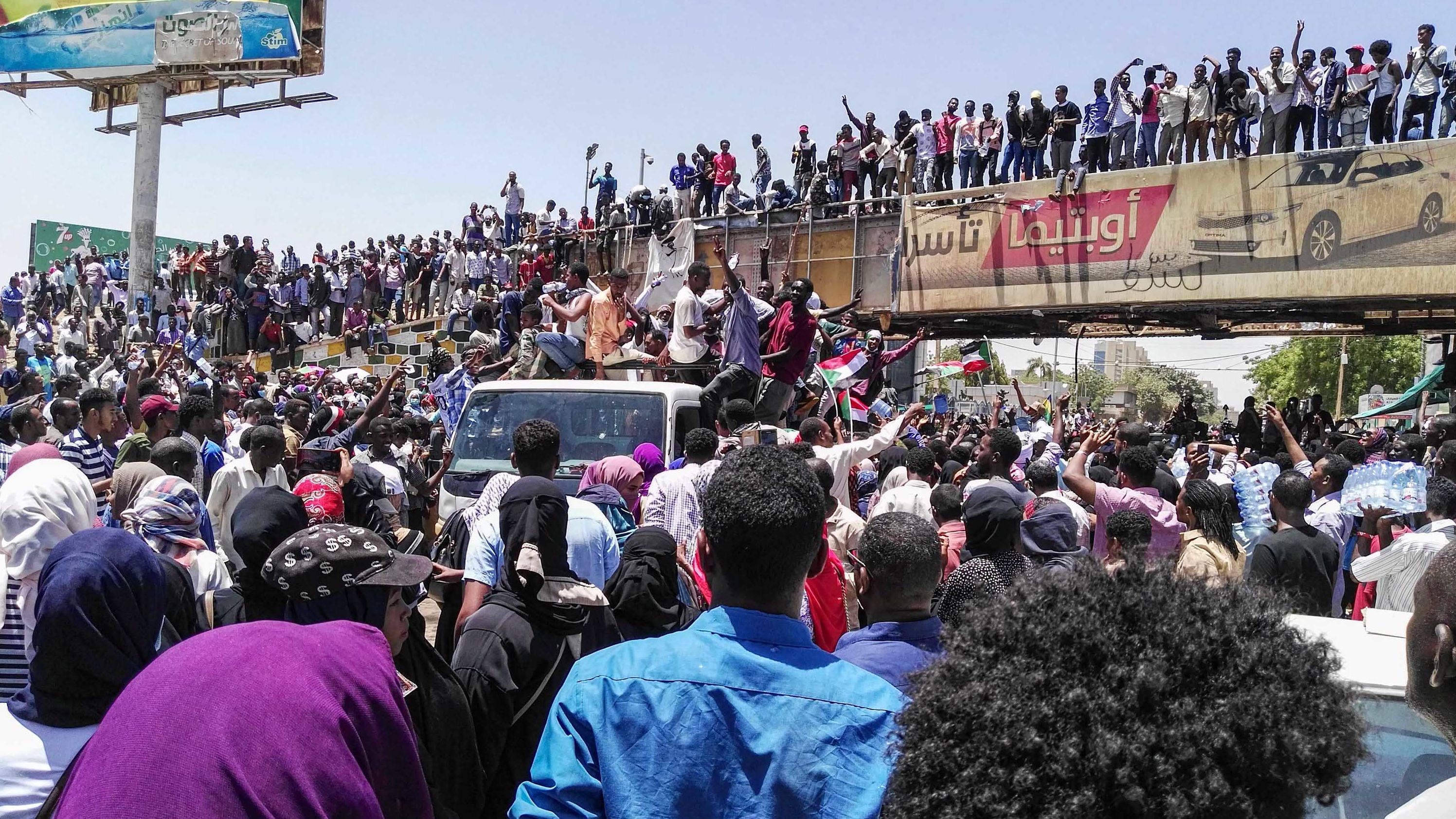 People protest on April 8, in front of the military headquarters in Khartoum.