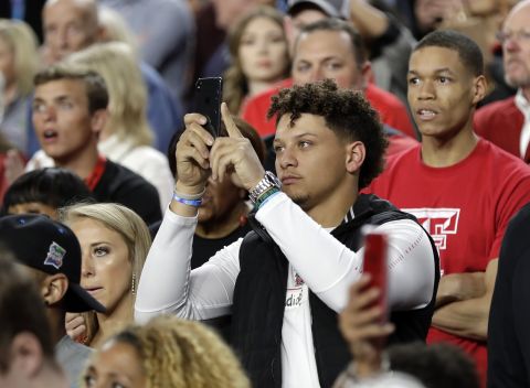 Patrick Mahomes, the NFL's Most Valuable Player this past season, takes pictures before the start of the game. Mahomes played football at Texas Tech.