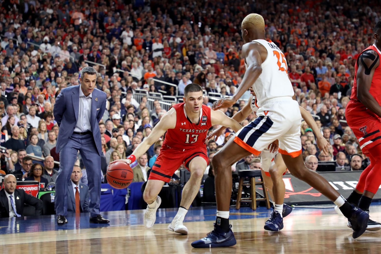 Bennett watches Mooney drive to the basket.