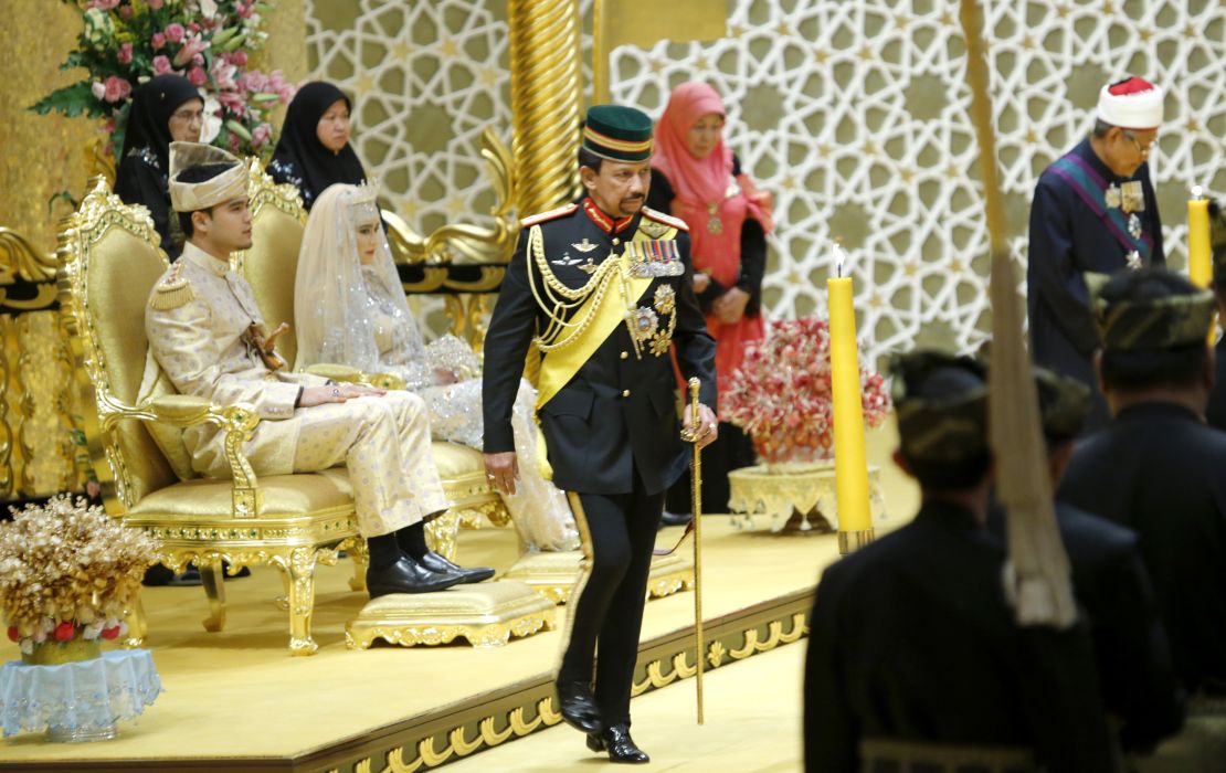 Brunei's Sultan Hassanal Bolkiah (center) returns after blessing to the royal couple Princess Hajah Hafizah Sururul Bolkiah and her groom Pengiran Haji Muhammad Ruzaini (left) at the end of the sitting-in-state on royal dais ceremony at Istana Nurul Iman in Brunei's capital Bandar Seri Begawan on September 23, 2012.  