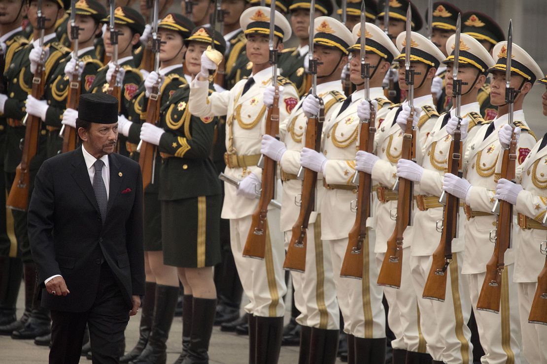 Brunei's Sultan Hassanal Bolkiah reviews a Chinese honor guard during a welcome ceremony at the Great Hall of the People in Beijing in September 2017.