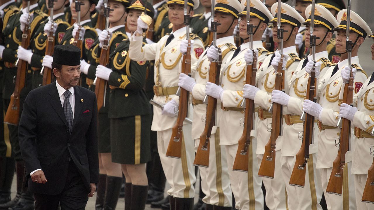 Brunei's Sultan Hassanal Bolkiah reviews a Chinese honor guard during a welcome ceremony at the Great Hall of the People in Beijing in September 2017.