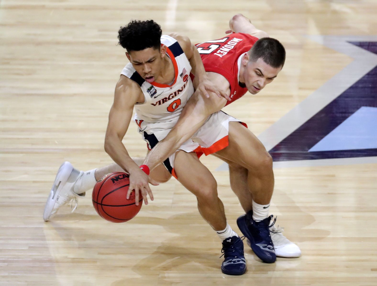 Mooney tries to steal the ball from Virginia's Kihei Clark during the second half.
