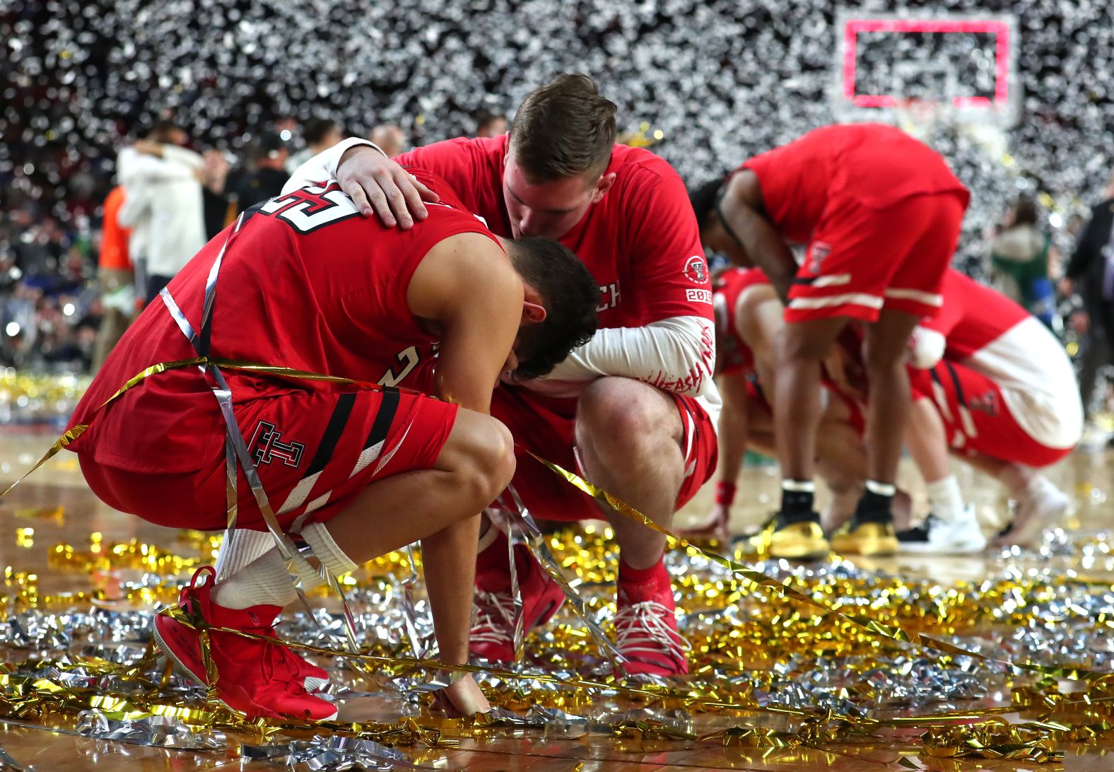 Texas Tech point guard Davide Moretti, left, is consoled by a teammate after the game.