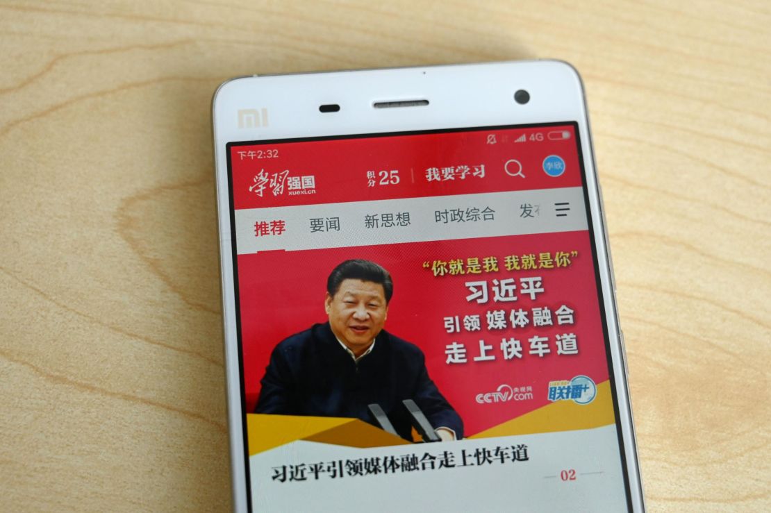 This photo illustratration from February shows a phone app called "Xuexi Qiangguo" or "Study to make China strong" with an image of China's President Xi Jinping in Beijing.
