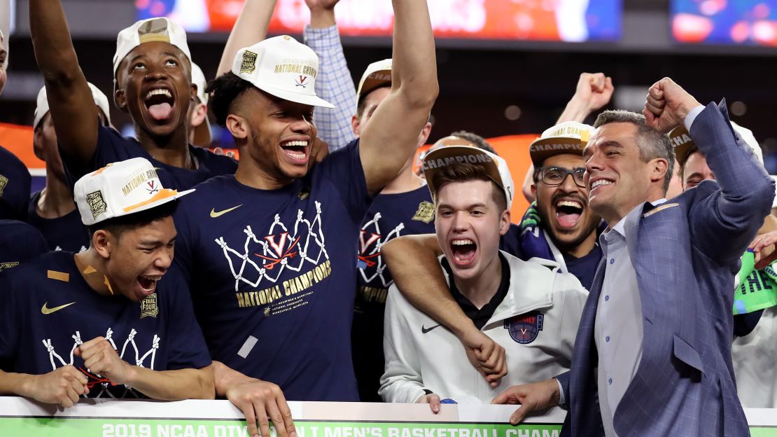 Virginia Cavaliers head coach Tony Bennett places his team's name as National Champion on the bracket after their 85-77 win over Texas Tech.