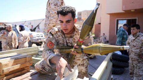 Members of Misrata forces, under the protection of Tripoli's forces, prepare themselves to go to the front line in Tripoli.