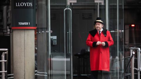A doorman stands outside the Lloyd's building in London in 2017.