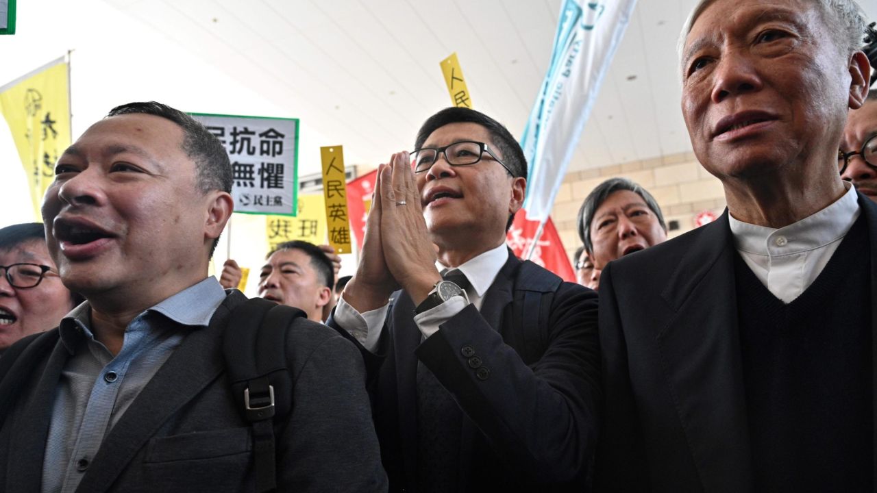 Baptist minister Chu Yiu-ming (R), law professor Benny Tai (L) and sociology professor Chan Kin-man (C) react as they enter the West Kowloon Magistrates Court in Hong Kong on April 9, 2019, to find out if they face jail for their involvement in the 2014 Umbrella Movement protests.