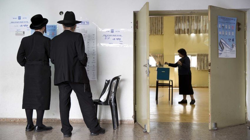 An ultra-Orthodox Jewish woman votes for Israel's parliamentary election at a polling station in Bnei Brak, Israel, Tuesday, April 9, 2019. (AP Photo/Oded Balilty)