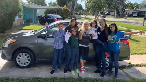 Samantha Rodriguez, second from right, and her family pose in front of her new car.