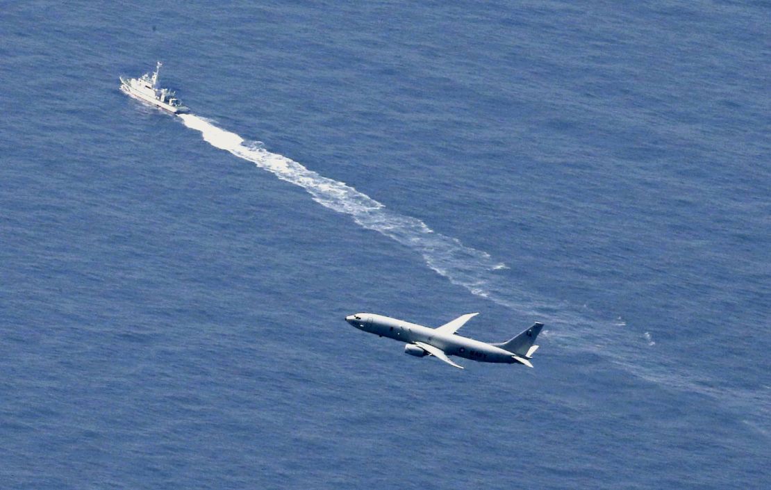 A Japan Coast Guard's vessel and US military plane search for a Japanese fighter jet, in the waters off Aomori, northern Japan, Wednesday, April 10, 2019.