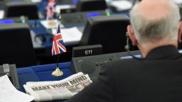 A newspaper headline focused on the Brexit and reading "Make your mind" is seen next to a MEP attending a debate on the preparation of the upcoming European Council meeting of March 21 and 22 and UK's withdrawal from the EU during a plenary session at the European Parliament on March 13, 2019 in Strasbourg, eastern France. - The European Union will have to hear from Britain how it plans to deliver a divorce deal agreement before deciding whether to delay Brexit, Brexit's negotiator said on March 13. (Photo by FREDERICK FLORIN / AFP)        (Photo credit should read FREDERICK FLORIN/AFP/Getty Images)