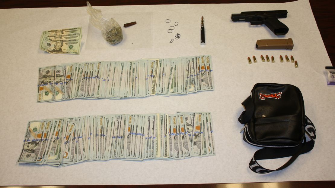 Police say they found $20,160 in cash, drugs and a gun in the rapper's car. 