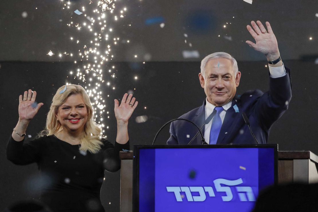 Benjamin Netanyahu, accompanied by his wife Sara, celebrates with supporters at his Likud Party HQ in Tel Aviv on election night.