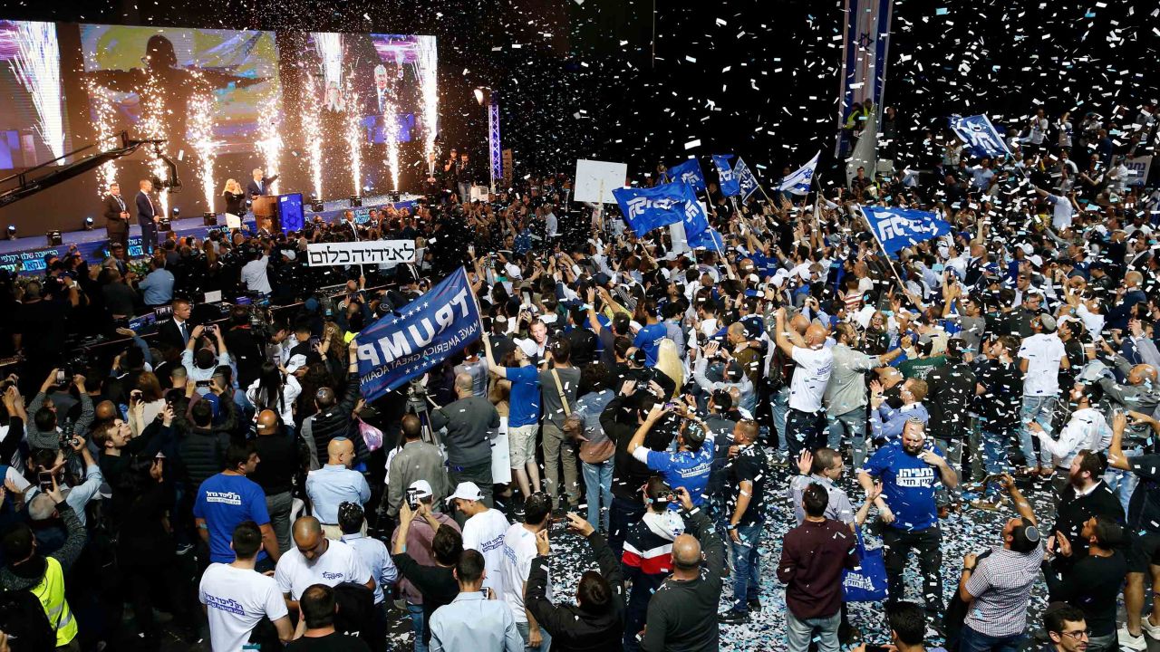 Likud supporters celebrate as Prime Minister Benjamin Netanyahu waves to them at its headquarters in Tel Aviv.