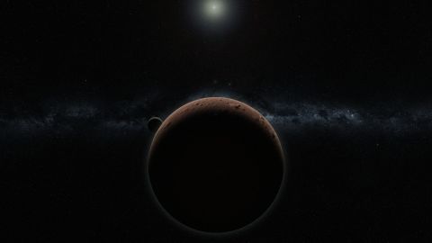Artist's concept of 2007 OR10 -- the largest unnamed solar system object yet discovered -- and its moon.
