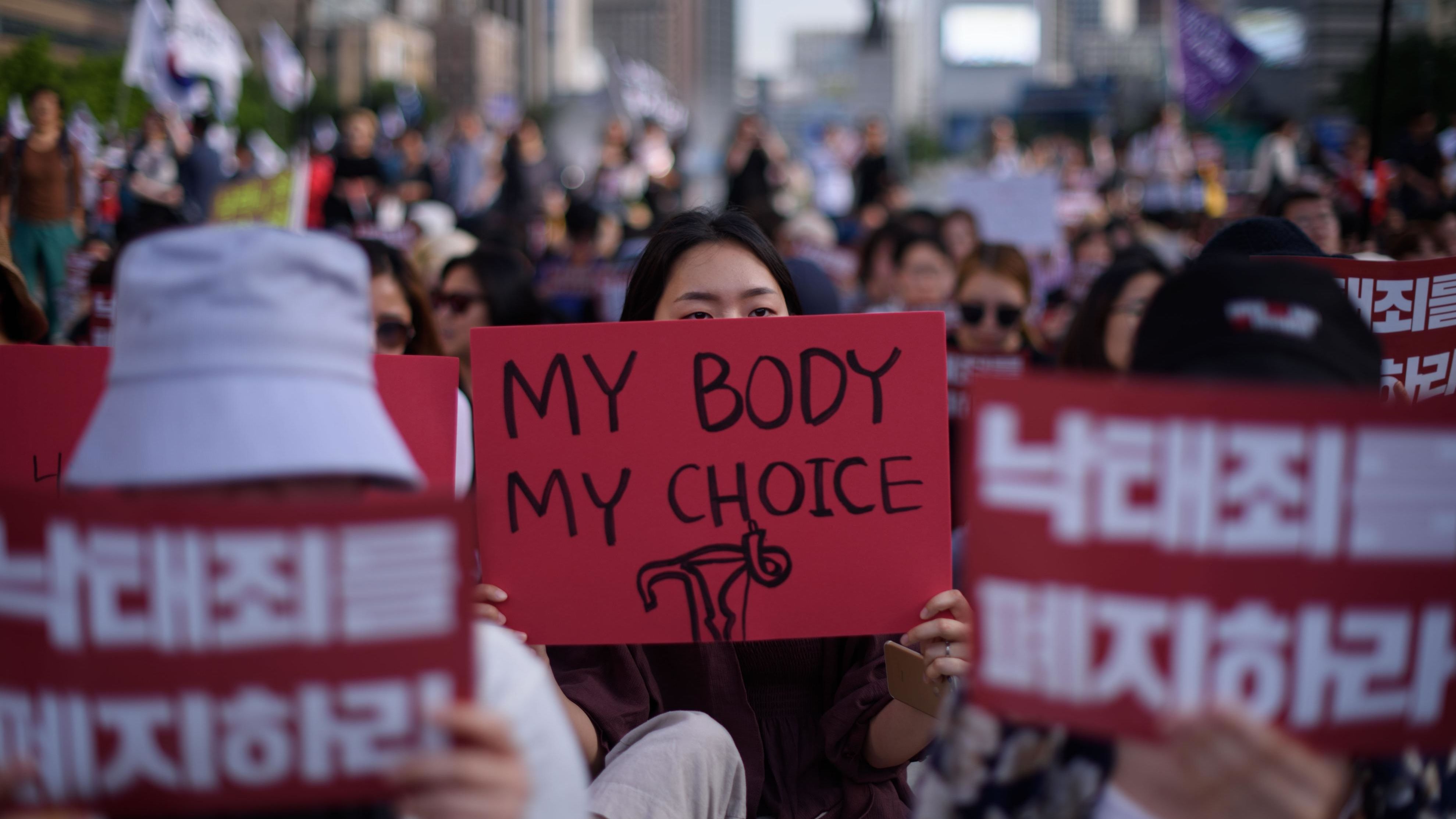 Protesters hold placards reading "Abolish punishment for abortion" as they protest South Korean abortion laws in Gwanghwamun plaza in Seoul on July 7, 2018.
