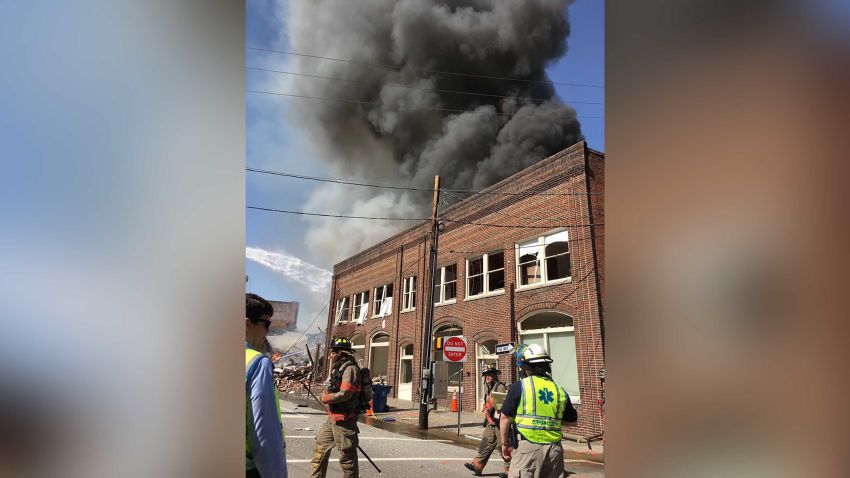 Firefighters are battling a blaze triggered by a suspected gas leak at a downtown Durham, NC building Wednesday morning, according to a series of tweets from the Durham Fire Department.