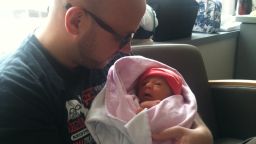 Eric Lohman holds Rosie in the hospital in August, 2012 - within a week of her birth - while awaiting a diagnosis.  